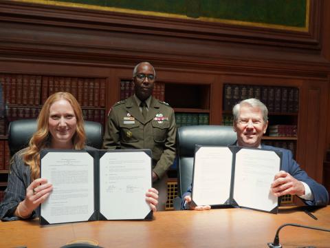 Executive Director Emily Domenech and Georgia Governor Brian Kemp displaying their signed MOU copies
