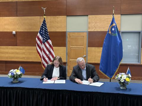 Executive Director Emily Domenech and Governor Joe Lombardo signing the Nevada MOU documents