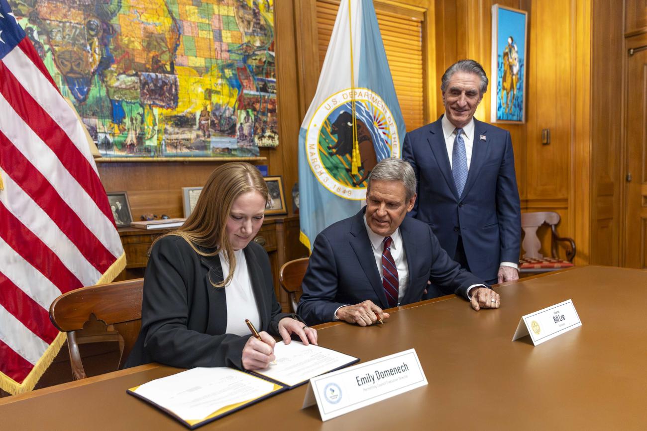 Executive Director Emily Domenech and Tennessee Governor Bill Lee signing a memorandum of understanding